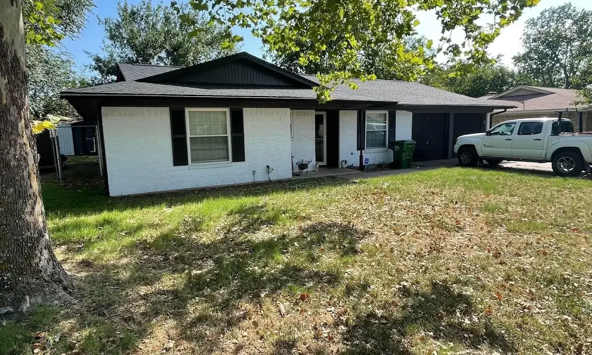 Professional roofing crew working on a residential roof in Ponca City